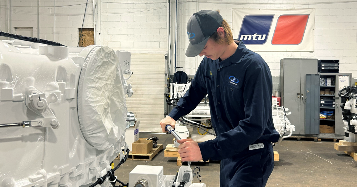 apprentice working on equipment in a shop